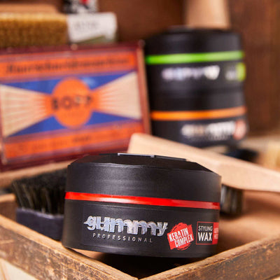 GUMMY STYLING WAX 150 ML ULTRA HOLD, watermelon scent, long-lasting strong hold hair wax in black container.