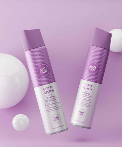 NishLady Crazy Styles Magic Dry Shampoo bottles on a purple background.